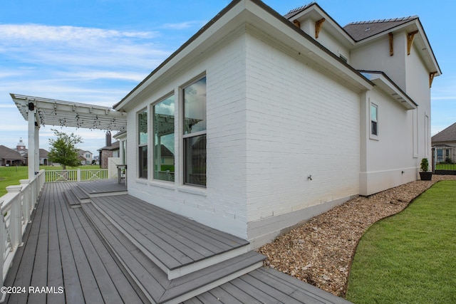 view of property exterior featuring a wooden deck and a pergola