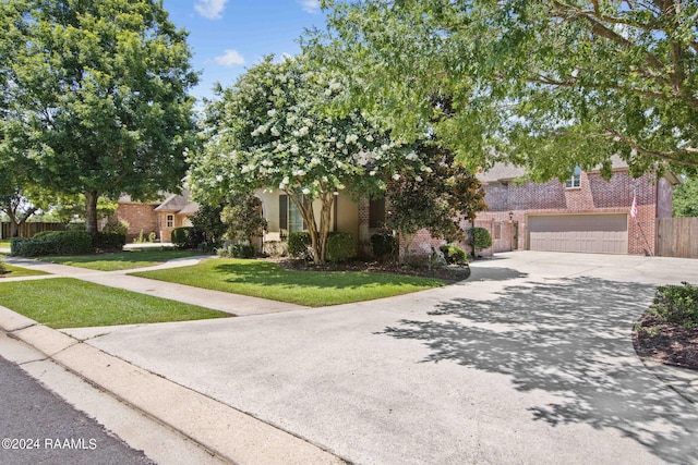 obstructed view of property with a garage and a front yard