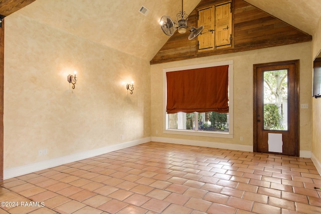 foyer featuring wooden ceiling, light tile patterned floors, and a wealth of natural light