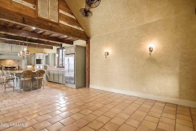 interior space featuring high vaulted ceiling, beamed ceiling, and light tile patterned floors