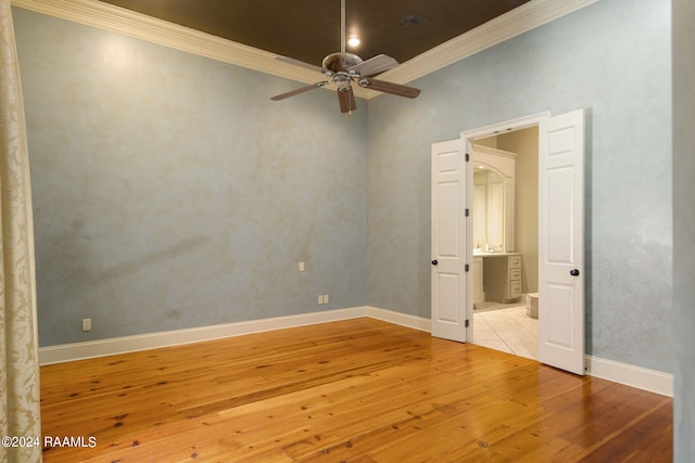 spare room featuring ornamental molding, light tile patterned floors, and ceiling fan