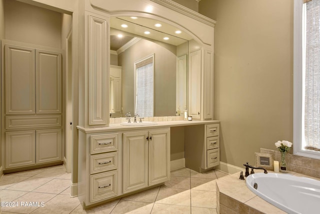 full bath with a relaxing tiled tub, crown molding, vanity, and tile patterned flooring