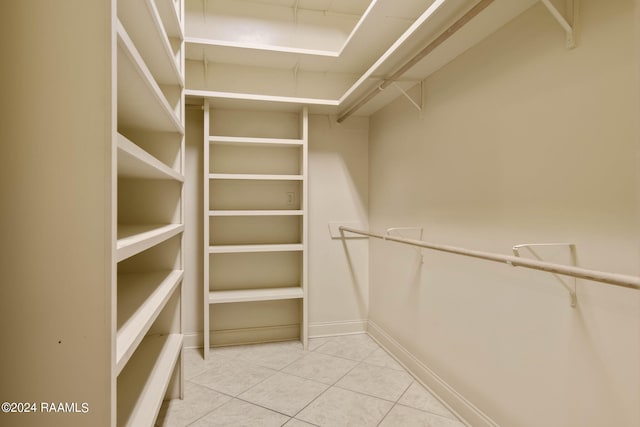 spacious closet featuring light tile patterned floors