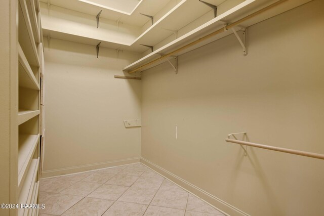 walk in closet featuring light tile patterned flooring