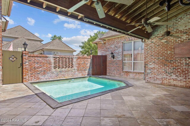 view of pool with ceiling fan, an in ground hot tub, and a patio area