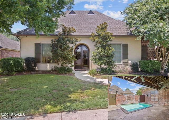 view of front facade featuring a front yard, a patio, and french doors