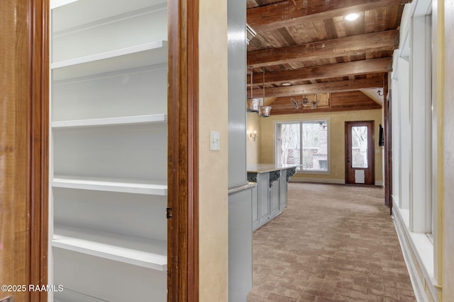 hallway with beamed ceiling and wood ceiling