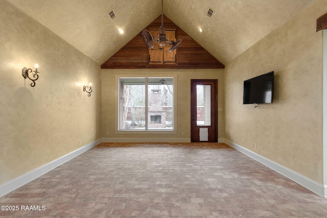 interior space with visible vents, lofted ceiling, and baseboards