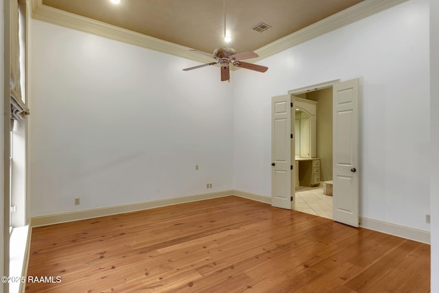 unfurnished bedroom with light wood finished floors, visible vents, baseboards, and ornamental molding