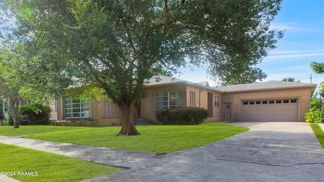 ranch-style house featuring a garage and a front yard