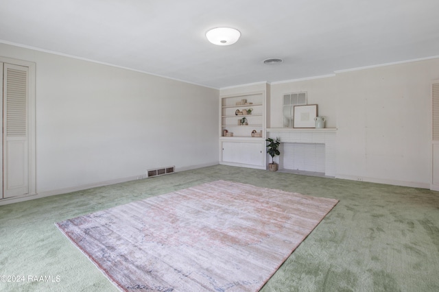 interior space with built in shelves and crown molding