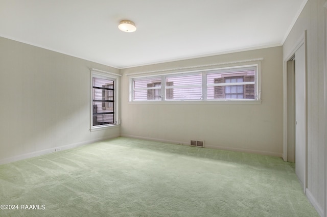 carpeted empty room with crown molding