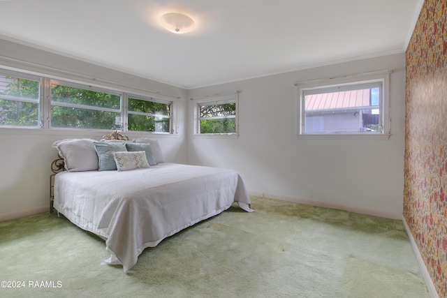 carpeted bedroom with ornamental molding