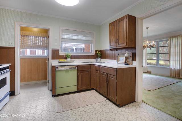 kitchen featuring crown molding, dishwasher, a chandelier, electric range, and wood walls