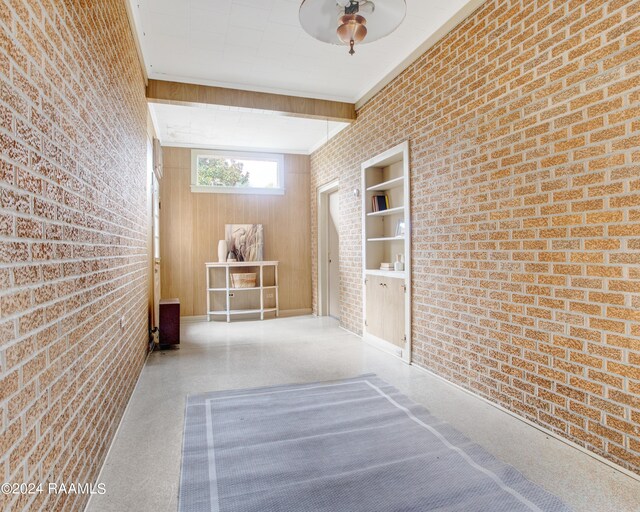 empty room featuring brick wall