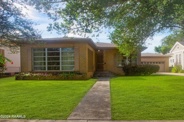 ranch-style house with a garage and a front lawn