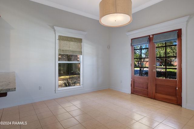 unfurnished dining area with light tile patterned floors, crown molding, and french doors