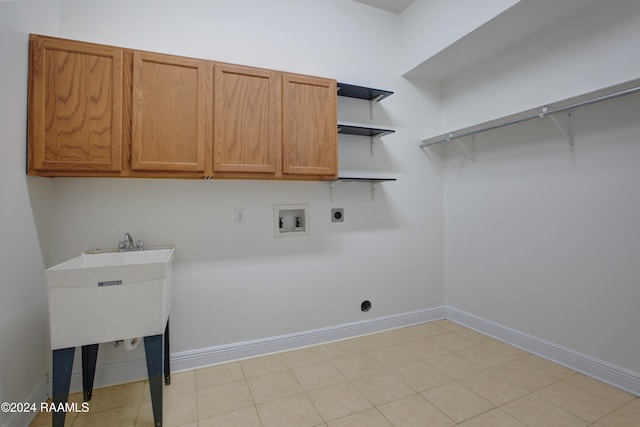 clothes washing area featuring electric dryer hookup, hookup for a washing machine, and cabinets