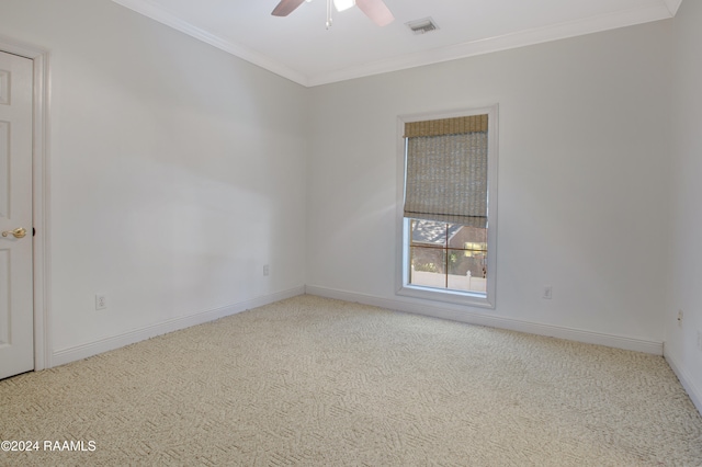 carpeted empty room featuring crown molding and ceiling fan