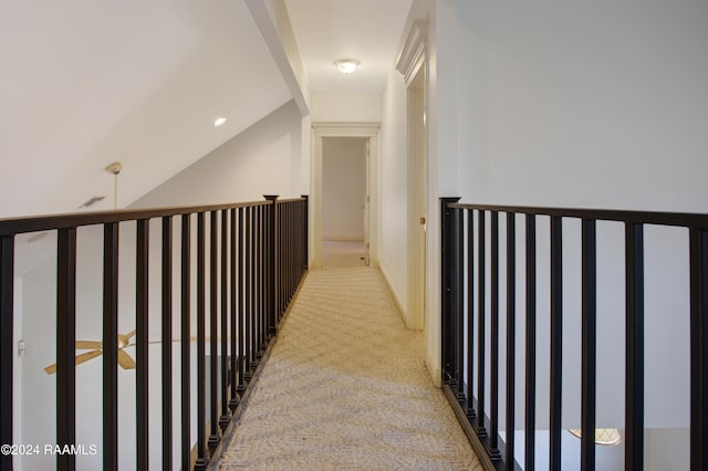 hall featuring light colored carpet