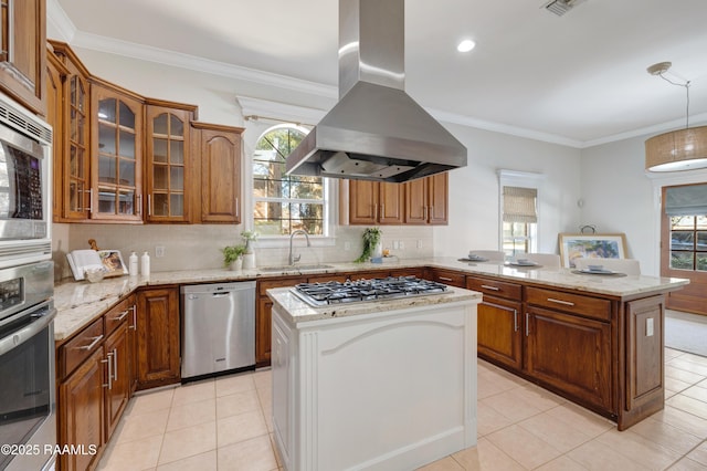 kitchen featuring light stone counters, island exhaust hood, appliances with stainless steel finishes, and a kitchen island