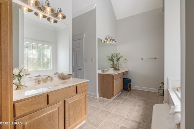 bathroom with crown molding, vanity, vaulted ceiling, and a tub