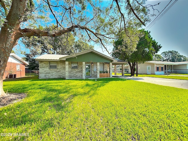 ranch-style home featuring a front lawn and central AC