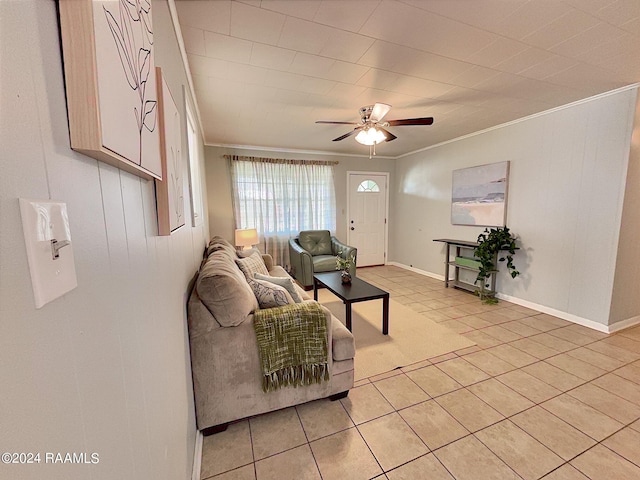 living room with ceiling fan, crown molding, and light tile patterned floors