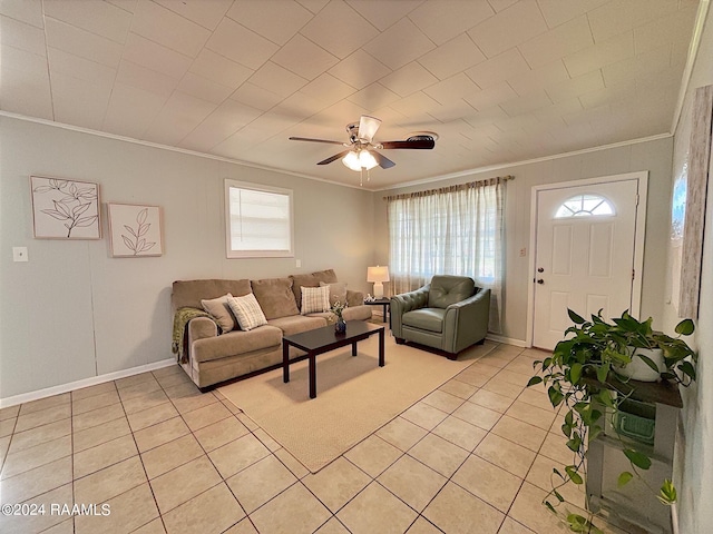 living room featuring ceiling fan, ornamental molding, and light tile patterned flooring