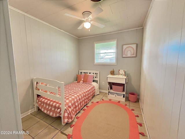 tiled bedroom with ceiling fan and ornamental molding