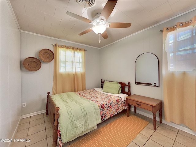 bedroom featuring ceiling fan, ornamental molding, and light tile patterned flooring