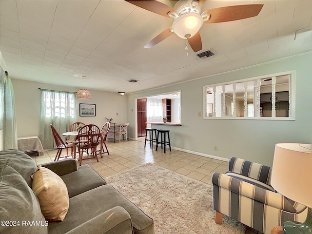 tiled living room with ceiling fan