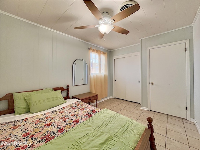 bedroom with ceiling fan, crown molding, and light tile patterned floors