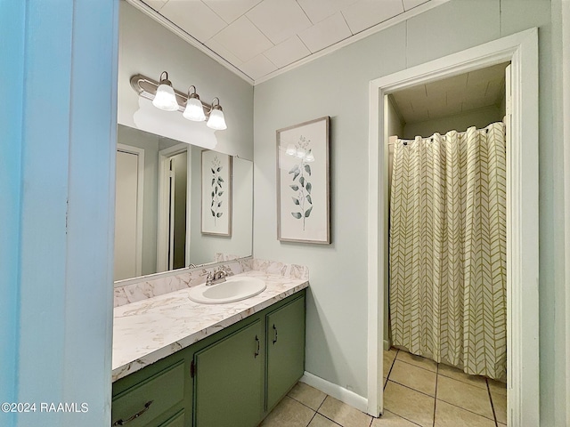 bathroom featuring vanity, crown molding, and tile patterned flooring