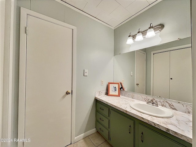 bathroom featuring crown molding, tile patterned floors, and vanity