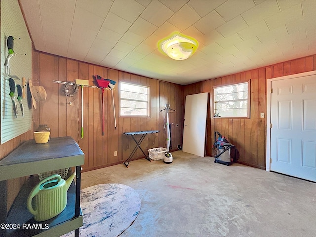 foyer with light carpet and wooden walls