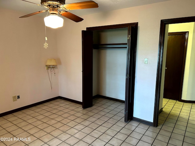 unfurnished bedroom featuring light tile patterned floors, ceiling fan, and a closet