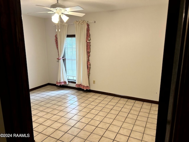 unfurnished room featuring ceiling fan and light tile patterned floors