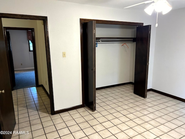 unfurnished bedroom with ceiling fan and a closet