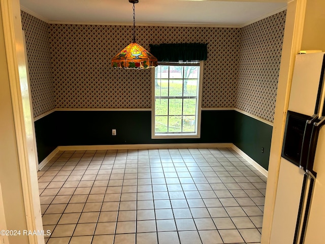 unfurnished dining area with light tile patterned floors and crown molding