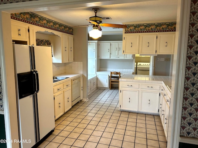 kitchen with ornamental molding, white cabinetry, tile counters, white appliances, and ceiling fan