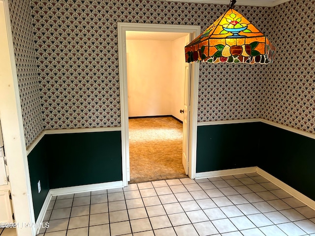 unfurnished dining area featuring light colored carpet