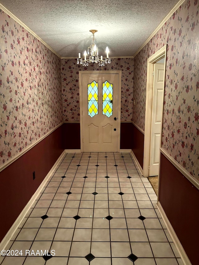 doorway to outside with ornamental molding, a notable chandelier, a textured ceiling, and light tile patterned flooring