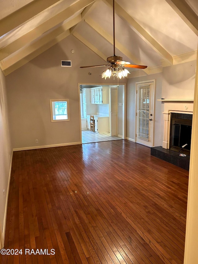 unfurnished living room with a fireplace, wood-type flooring, vaulted ceiling with beams, and ceiling fan