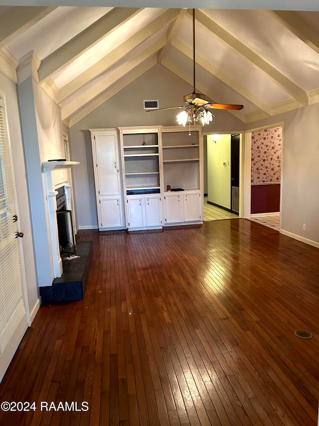 unfurnished living room featuring vaulted ceiling with beams, hardwood / wood-style flooring, and ceiling fan