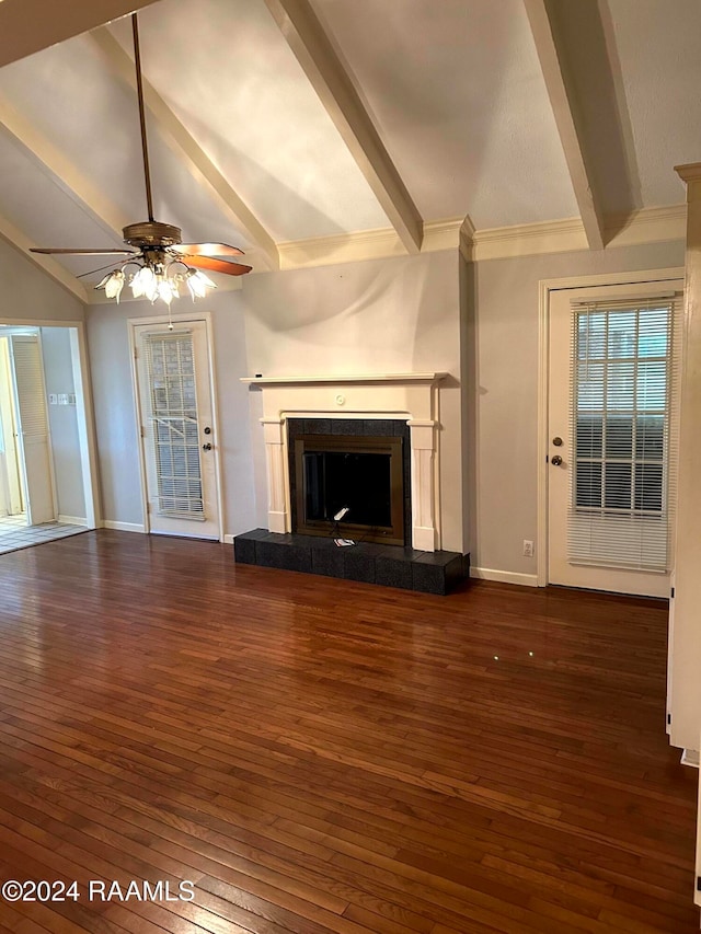 unfurnished living room featuring dark wood-type flooring, a fireplace, vaulted ceiling with beams, and ceiling fan