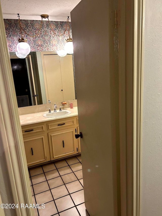 bathroom featuring vanity, a textured ceiling, and tile patterned floors