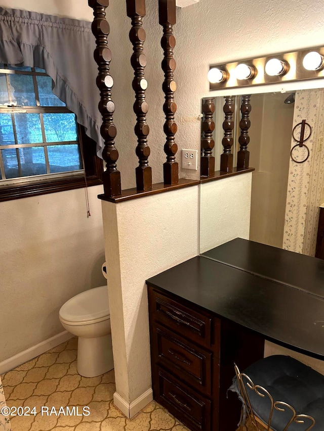 bathroom featuring vanity, tile patterned floors, and toilet