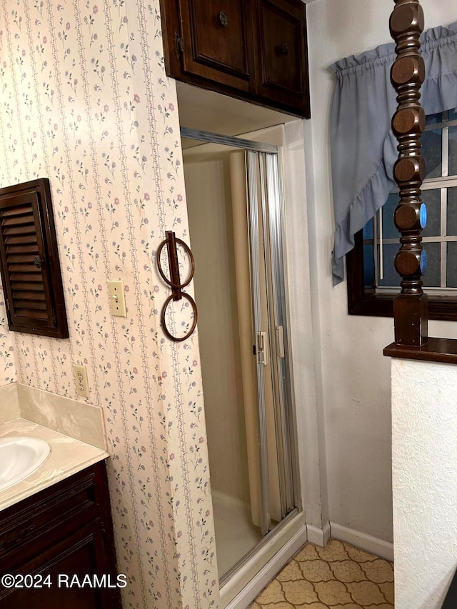 bathroom featuring walk in shower and vanity