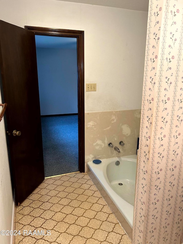 bathroom with a relaxing tiled tub